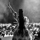 Congolese singer Dena Mwana in front of a crowd.